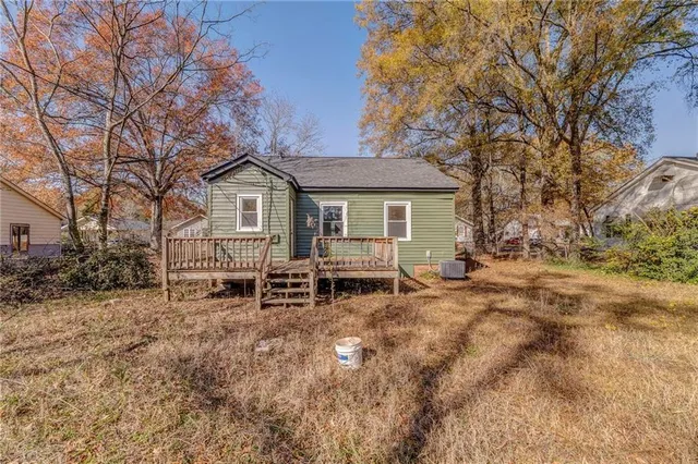 a view of a house with a yard and sitting area