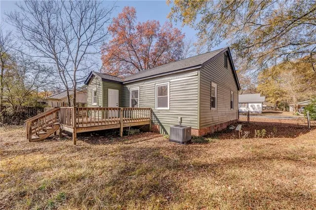 a view of a house with a yard and sitting area