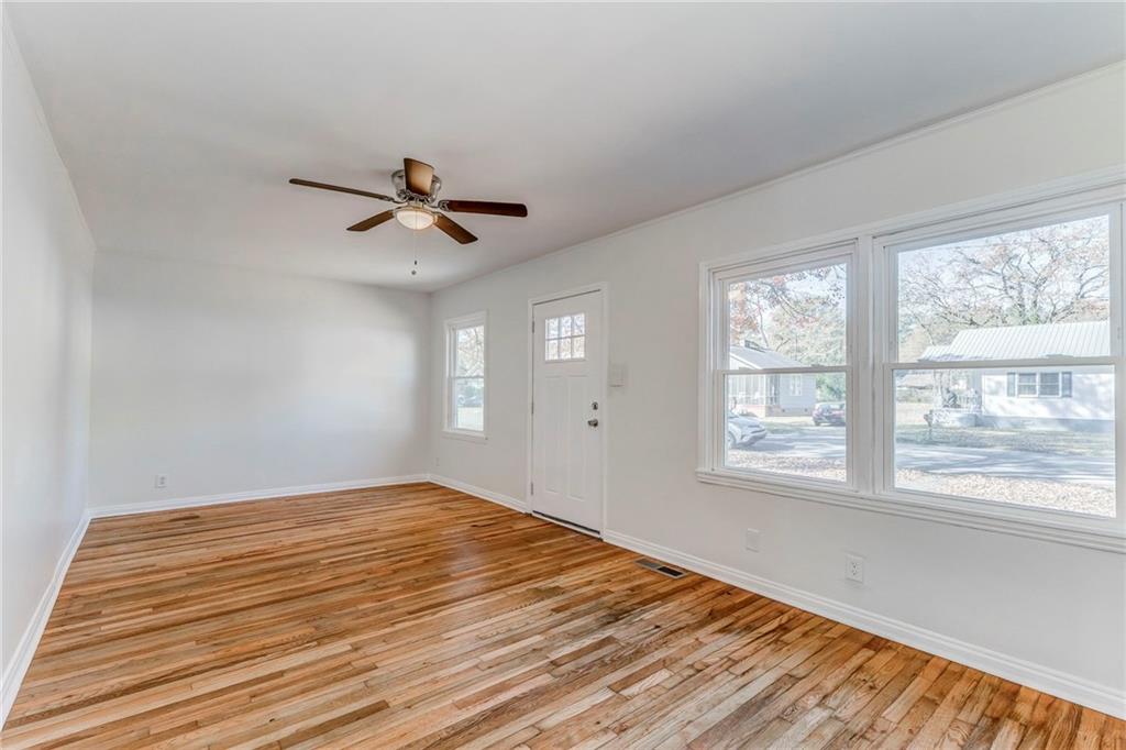 535 1st Street Northeast Rome, GA 30161 - Photo 3 of 34 a view of empty room with wooden floor and fan