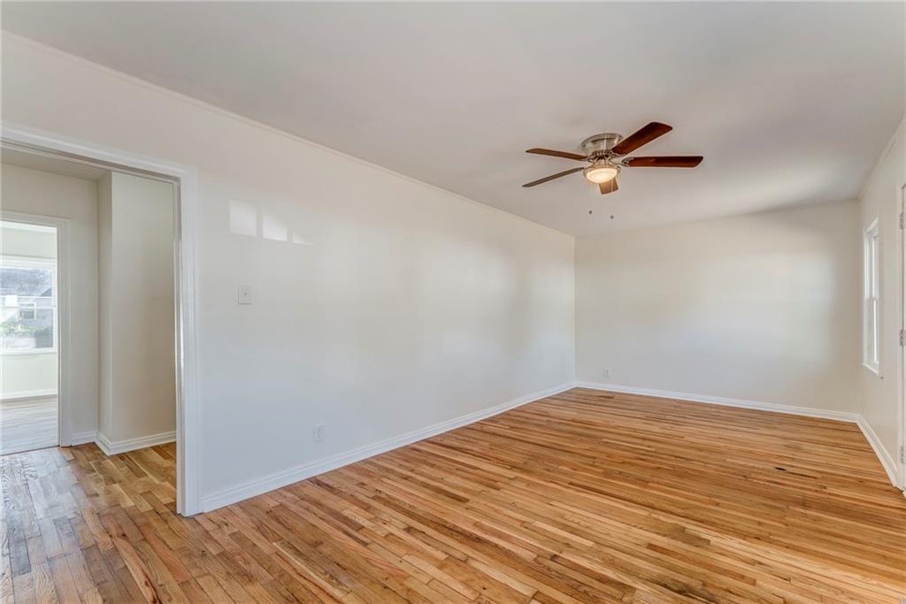535 1st Street Northeast Rome, GA 30161 - Photo 6 of 34 a view of a big room with wooden floor and a ceiling fan
