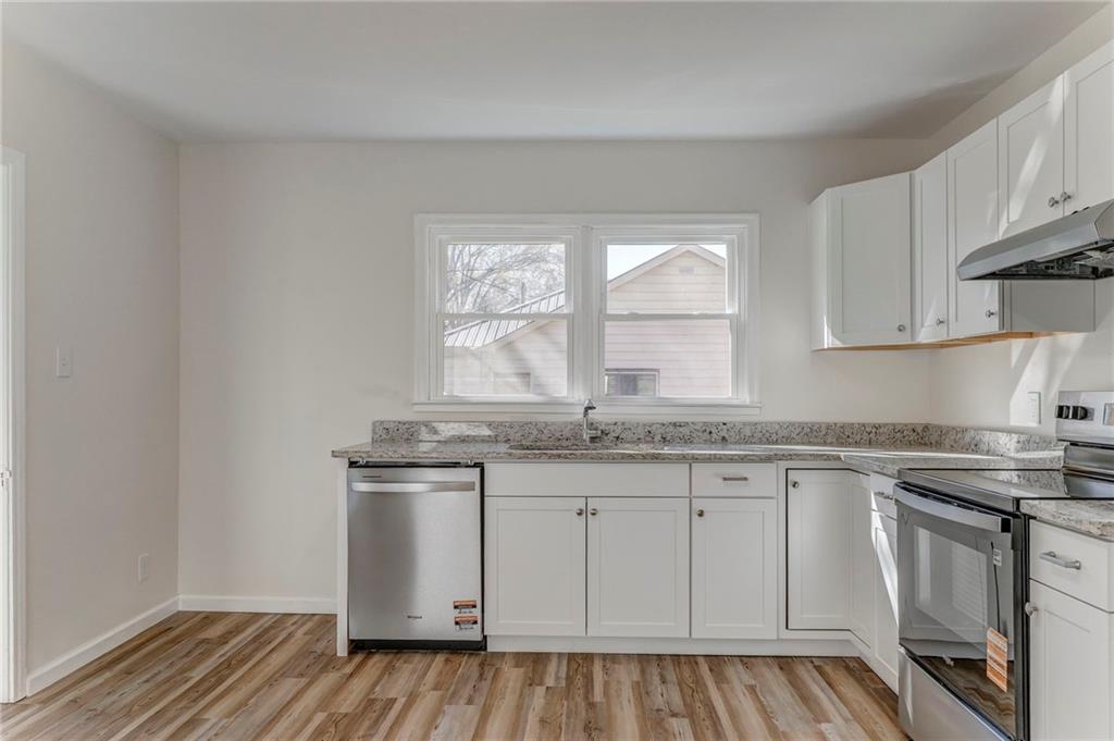 535 1st Street Northeast Rome, GA 30161 - Photo 7 of 34 a kitchen with granite countertop white cabinets and white appliances