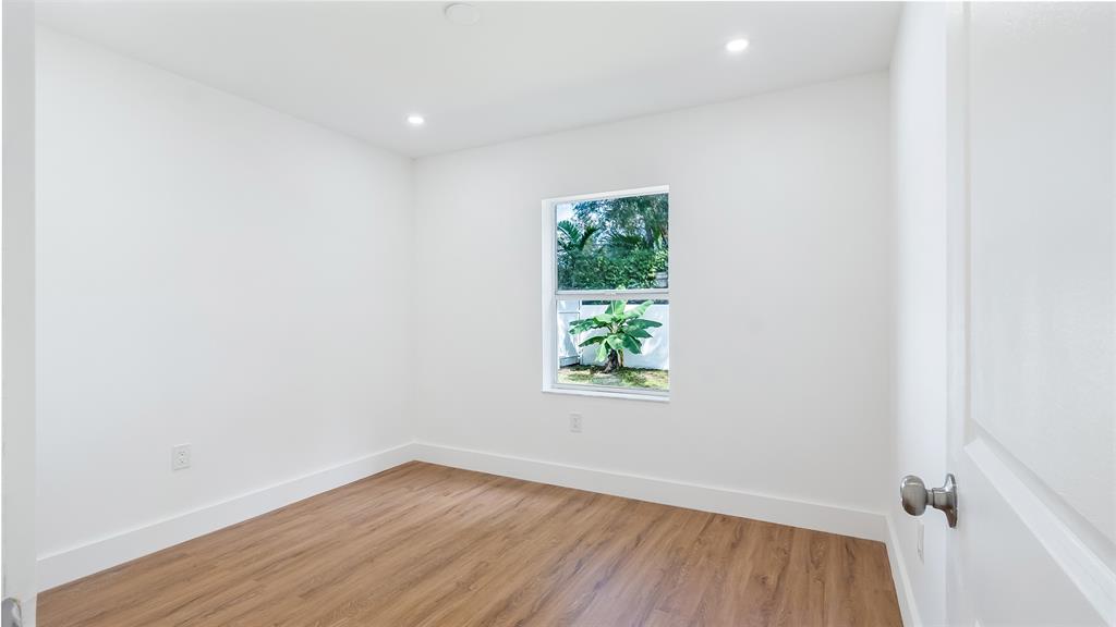 1811 Southwest 124th Way Miramar, FL 33027 - Photo 13 of 28 an empty room with wooden floor and window