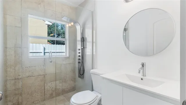a bathroom with a sink toilet and shower
