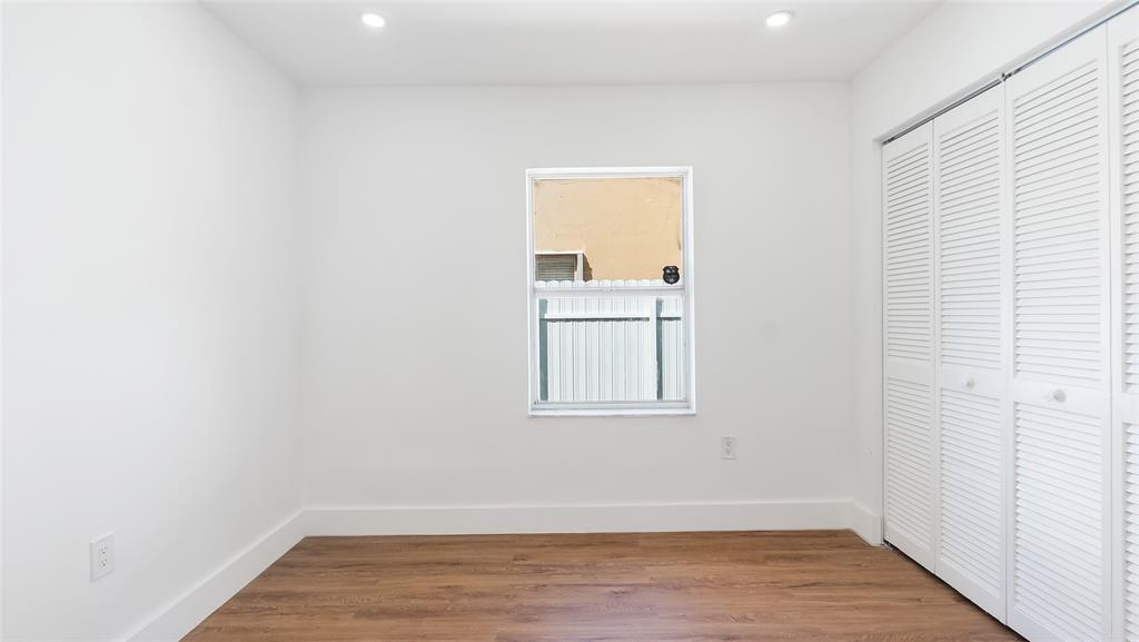 1811 Southwest 124th Way Miramar, FL 33027 - Photo 18 of 28 a view of an empty room with wooden floor and a window