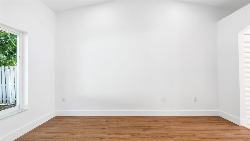 1811 Southwest 124th Way Miramar, FL 33027 - Photo 22 of 28 a view of an empty room with wooden floor and a window