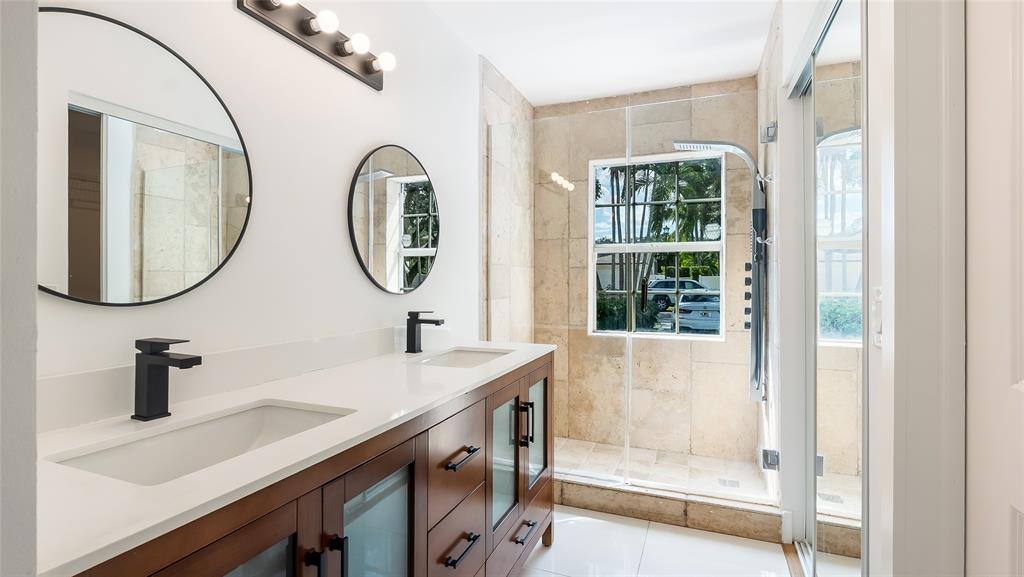 1811 Southwest 124th Way Miramar, FL 33027 - Photo 24 of 28 a bathroom with a double vanity sink and a mirror