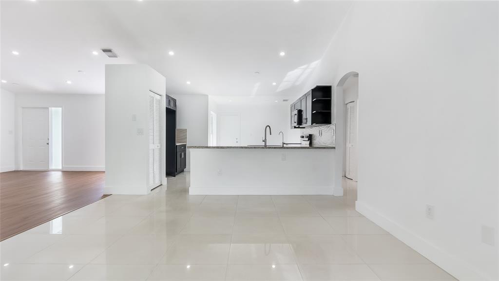 1811 Southwest 124th Way Miramar, FL 33027 - Photo 8 of 28 a view of a kitchen with a refrigerator and a stove top oven