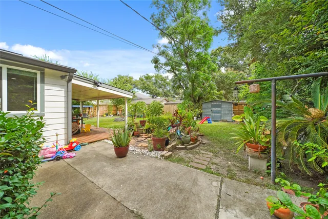 a view of a patio with table and chairs potted plants