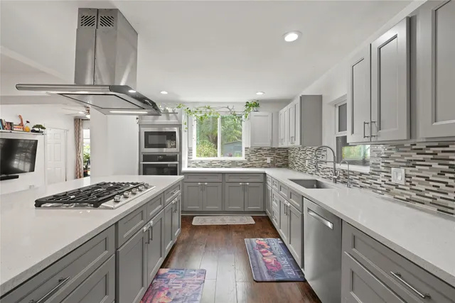 a kitchen with stainless steel appliances granite countertop a stove and a sink