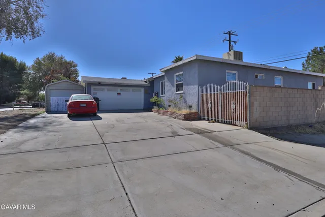 a front view of a house with cars