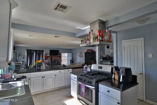 a kitchen with stainless steel appliances granite countertop a stove and cabinets
