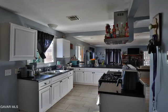 a kitchen with stainless steel appliances granite countertop a stove and cabinets
