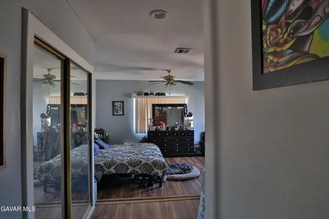 a bedroom with a bed and a mirror