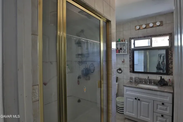 a bathroom with a granite countertop sink mirror and double