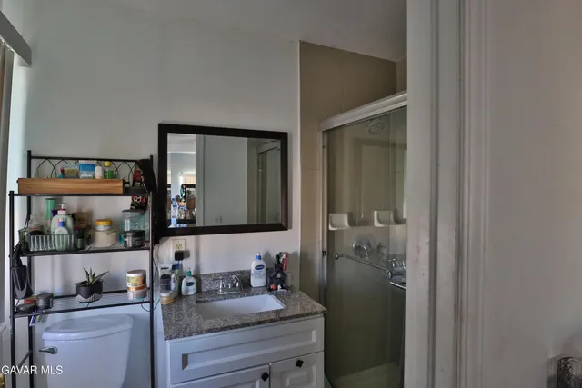 a bathroom with a granite countertop sink mirror and vanity