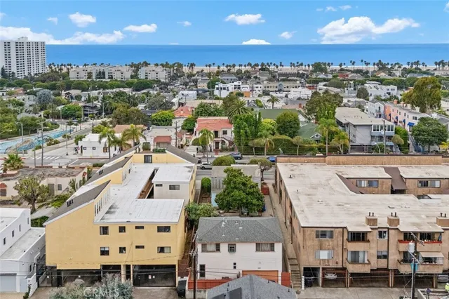 an aerial view of residential houses with city view