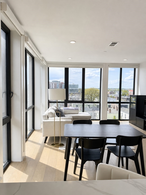 a living room with furniture and large windows
