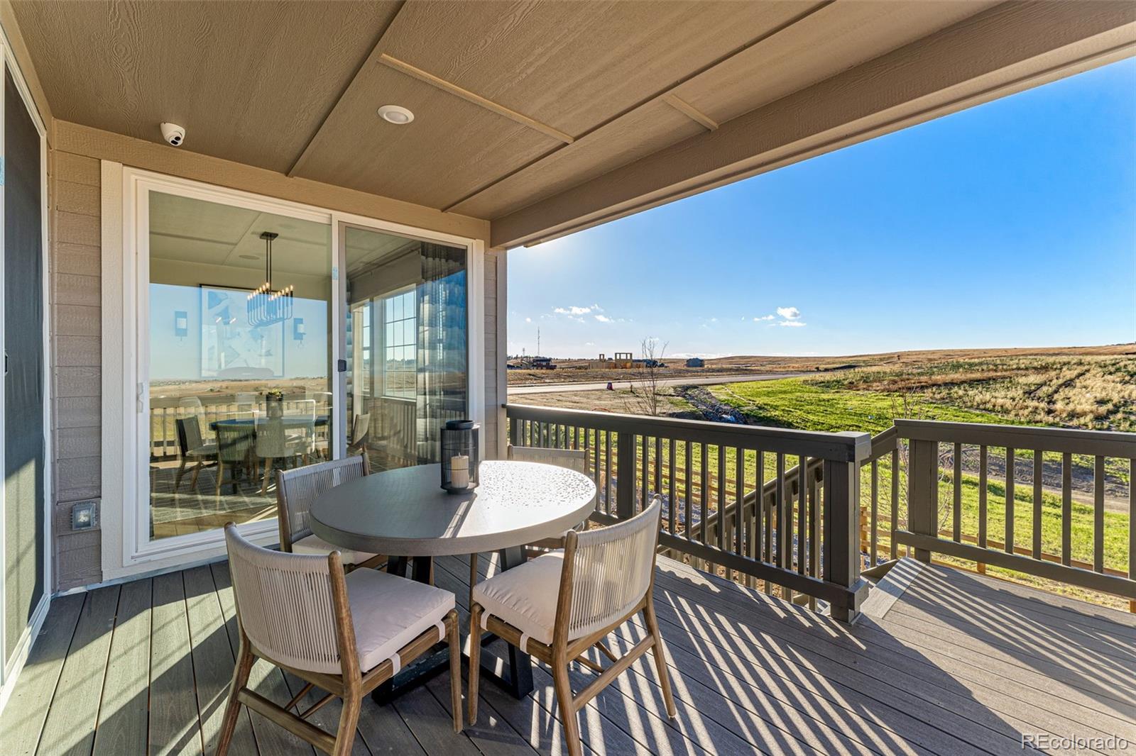 39782 Penn Road Elizabeth, CO 80107 - Photo 11 of 37 a view of a balcony with furniture and wooden floor