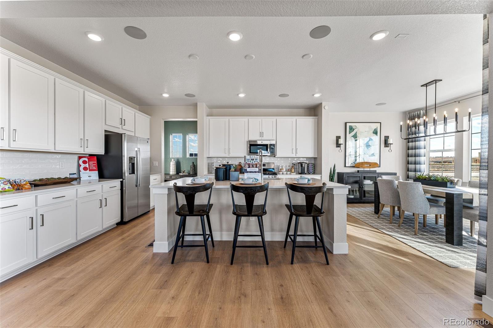 39782 Penn Road Elizabeth, CO 80107 - Photo 12 of 37 a living room with stainless steel appliances kitchen island granite countertop wooden floor a dining table and chairs