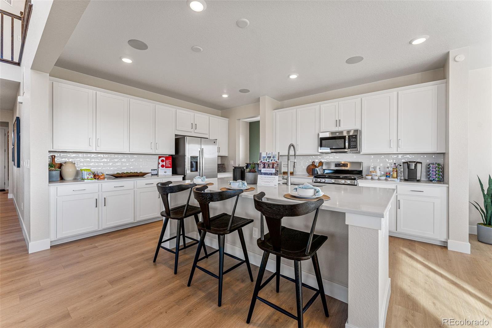 39782 Penn Road Elizabeth, CO 80107 - Photo 14 of 37 a kitchen with white cabinets appliances and chairs