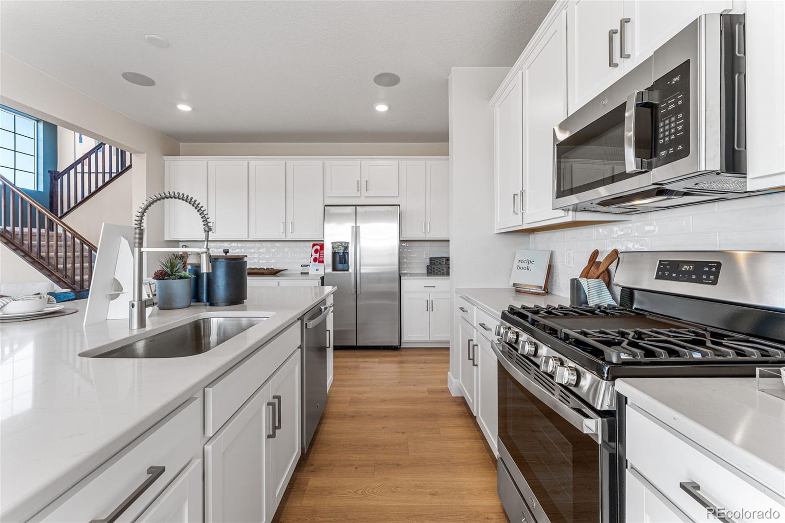 39782 Penn Road Elizabeth, CO 80107 - Photo 15 of 37 a kitchen with kitchen island stainless steel appliances a sink stove and cabinets