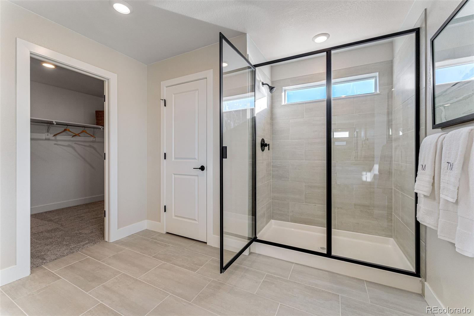 39782 Penn Road Elizabeth, CO 80107 - Photo 25 of 37 a bathroom with a glass shower door and a sink