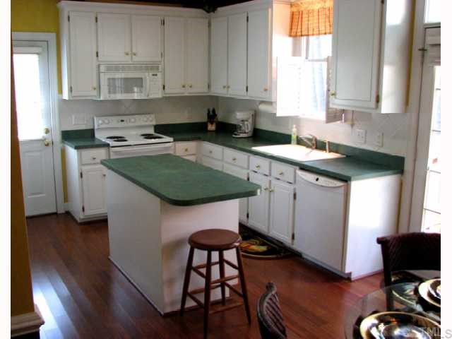 3008 Dahlgreen Road Raleigh, NC 27615 - Photo 3 of 9 Bright kitchen with working cook's island and white cabinets... all set off by super rich hardwood floor. Side door makes bringing in the groceries a breeze!