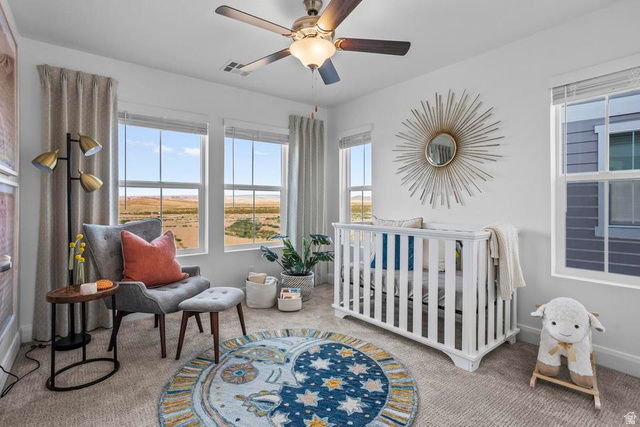 488 West Greenstone Pl Street, Unit 1010 St. George, UT 84790 - Photo 31 of 34 Carpeted room featuring multiple large windows, a ceiling fan with integrated lighting, and a neutral color palette