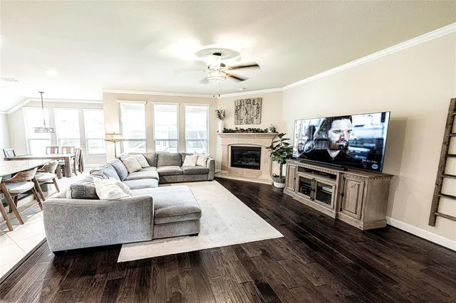 a living room with furniture fireplace and flat screen tv