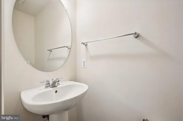 a bathroom with a sink a mirror and a shower