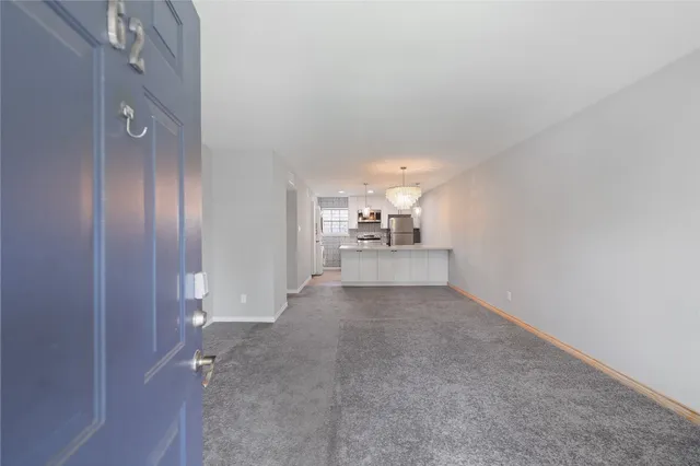 a view of a big room with chandelier fan and windows