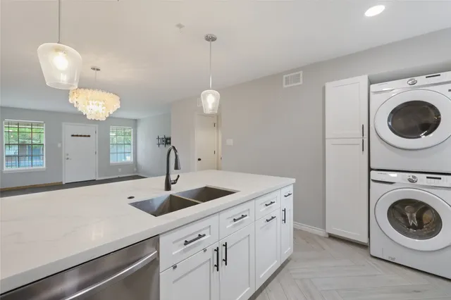 a kitchen with sink and cabinets