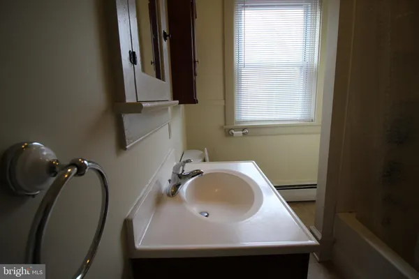 a bathroom with a sink a mirror and a window