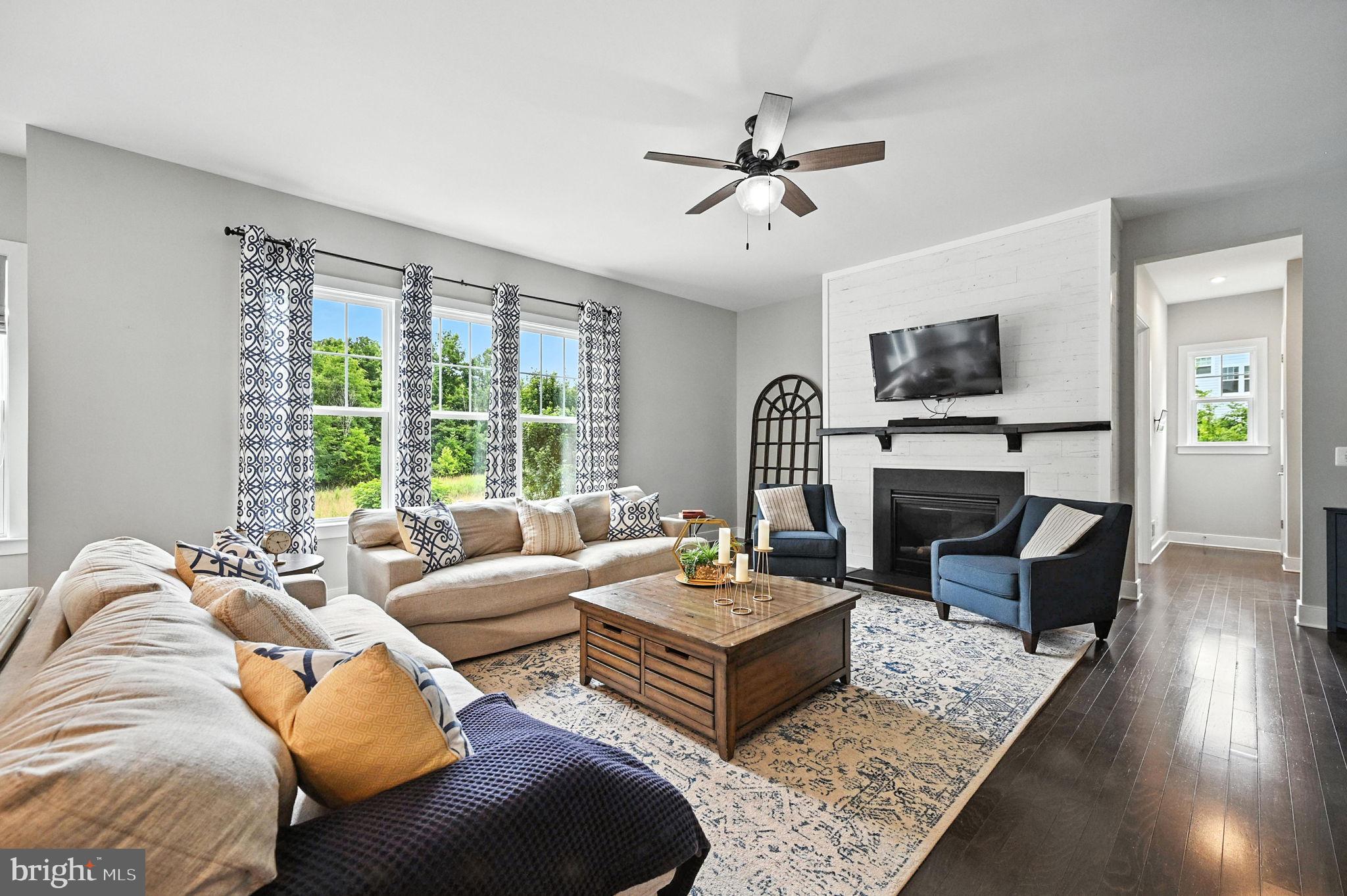 40960 River Cane Place Aldie, VA 20105 - Photo 18 of 54 a living room with furniture a fireplace and a flat screen tv