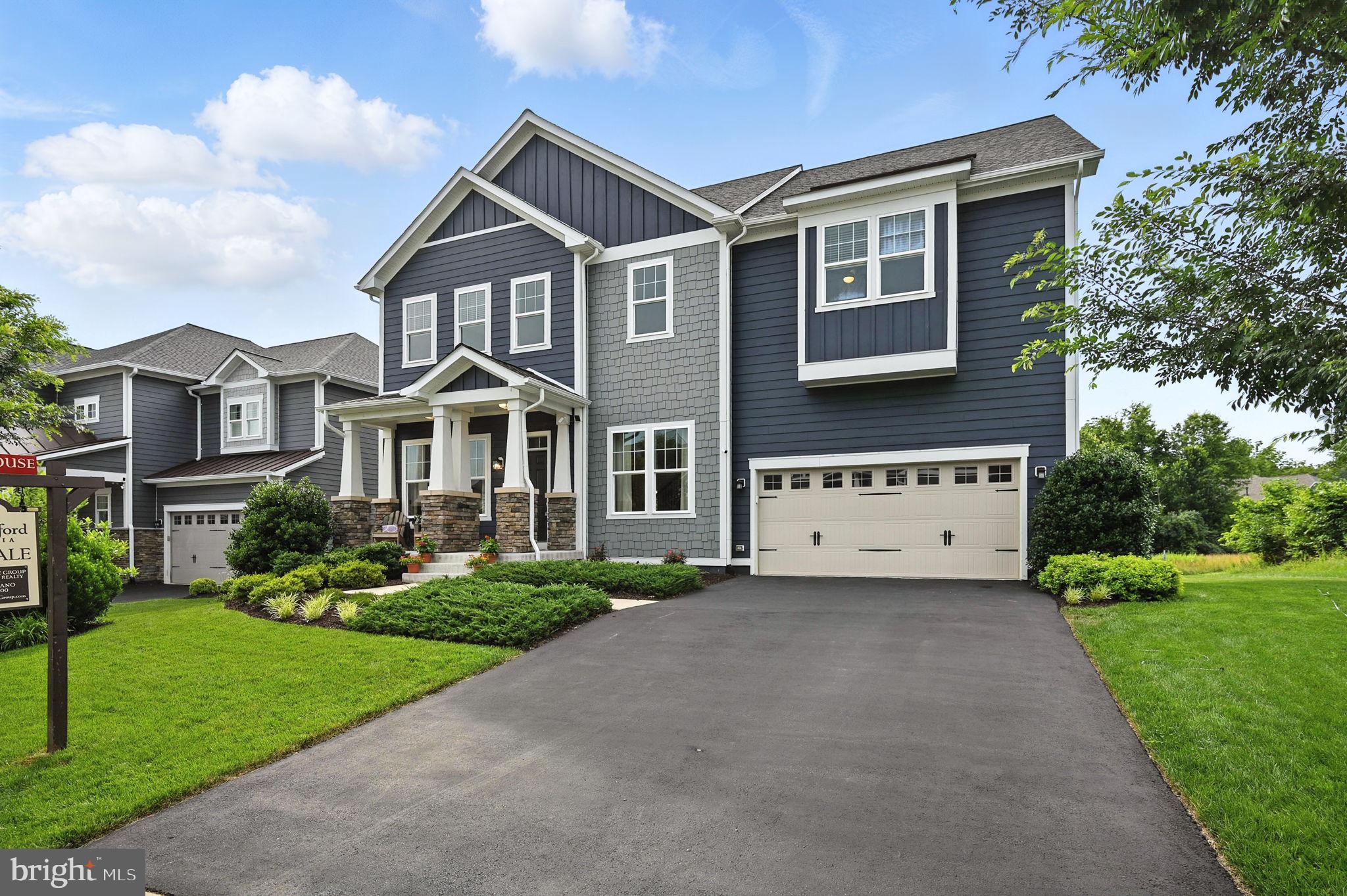 40960 River Cane Place Aldie, VA 20105 - Photo 2 of 54 a front view of a house with a yard and garage