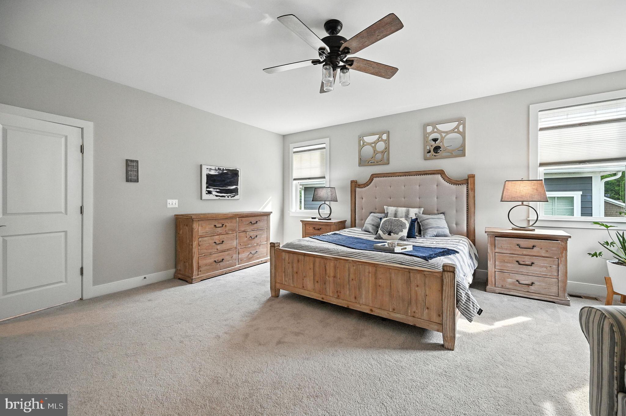 40960 River Cane Place Aldie, VA 20105 - Photo 21 of 54 a spacious bedroom with a bed and a chandelier