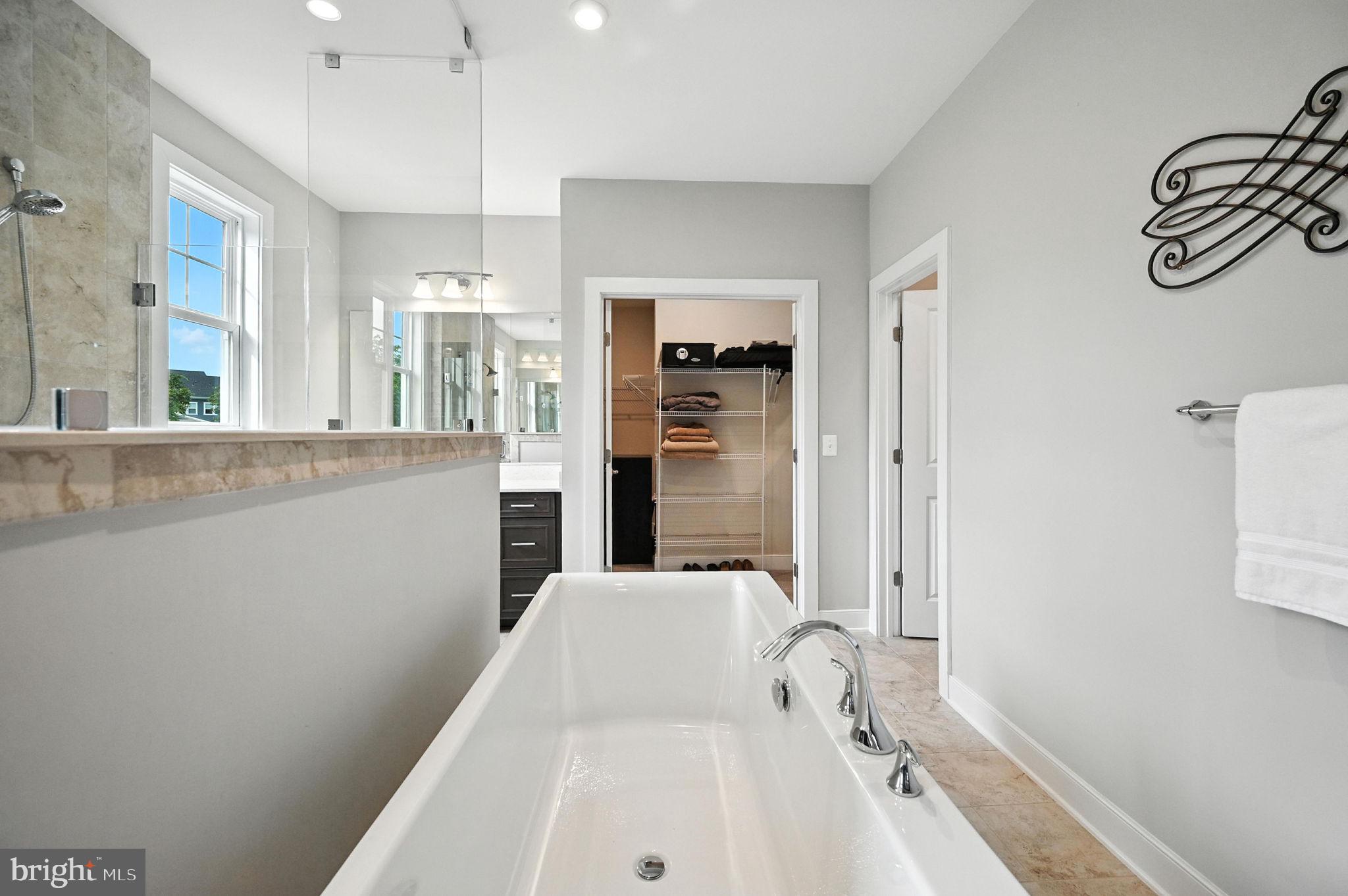40960 River Cane Place Aldie, VA 20105 - Photo 25 of 54 a bathroom with a bathtub and a shower