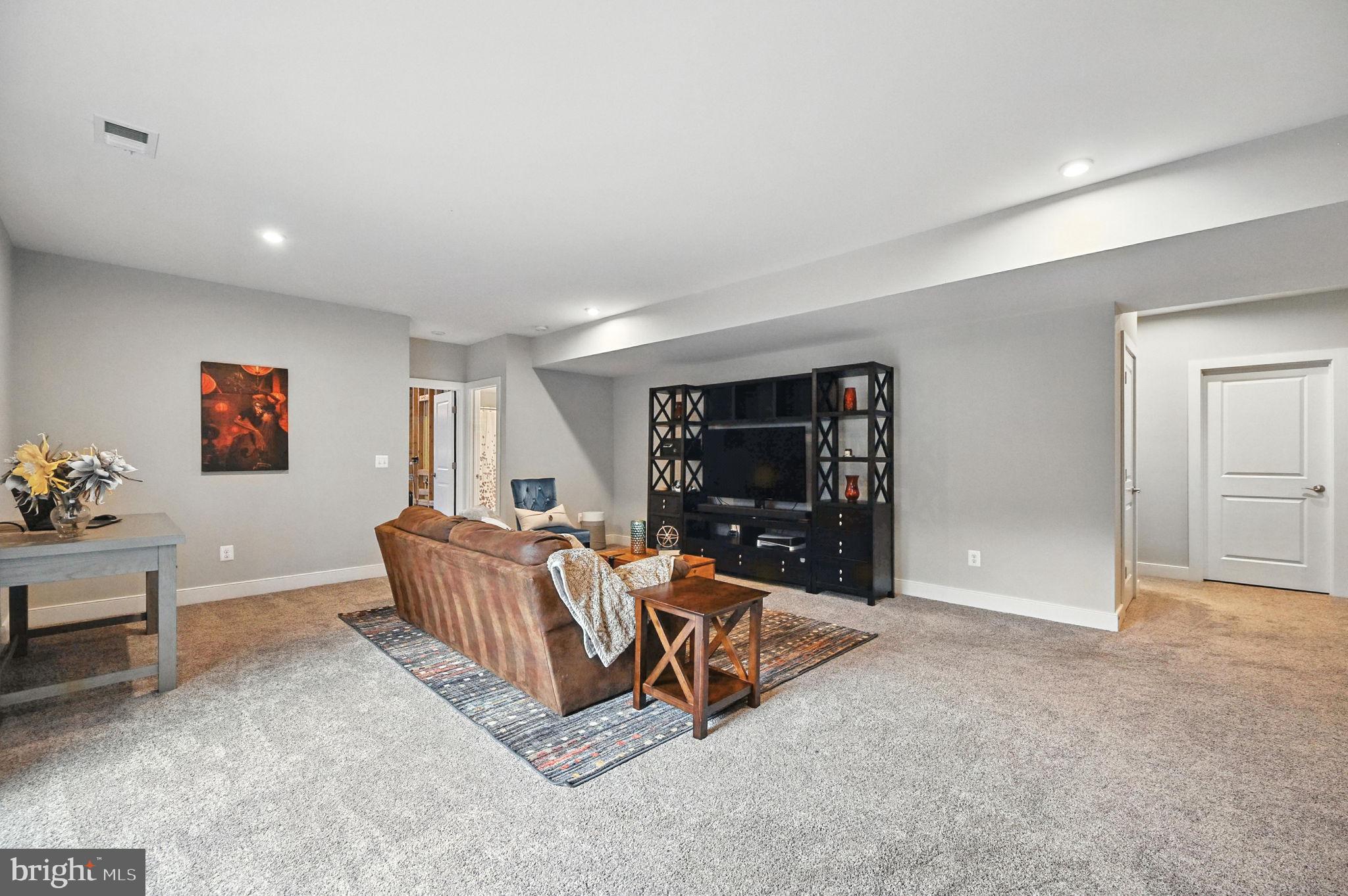 40960 River Cane Place Aldie, VA 20105 - Photo 27 of 54 a living room with furniture and a flat screen tv
