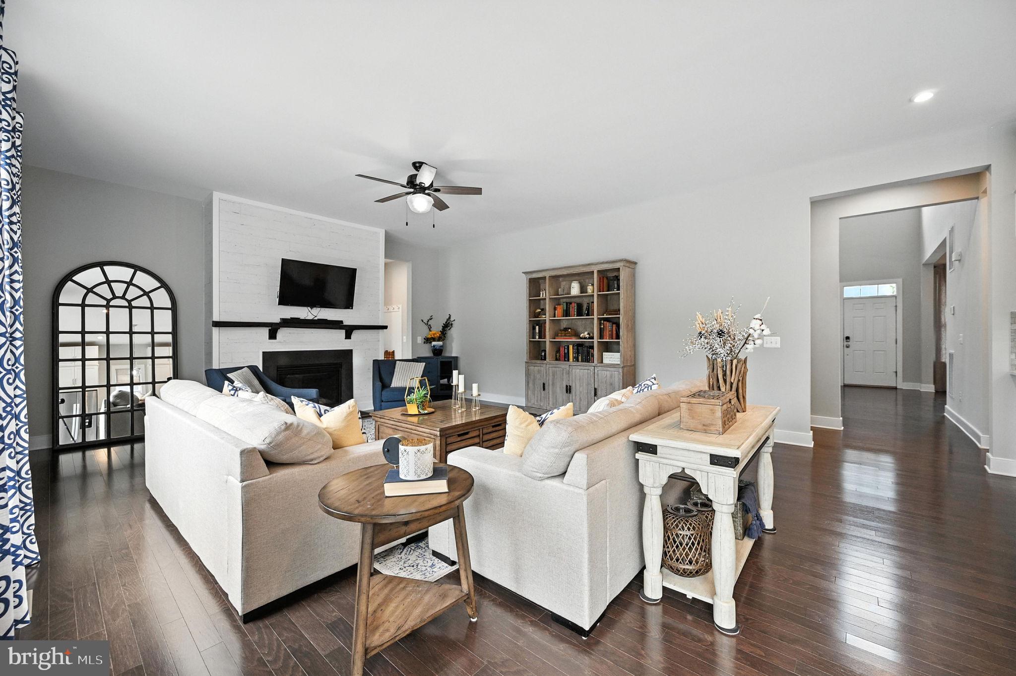 40960 River Cane Place Aldie, VA 20105 - Photo 32 of 54 a living room with furniture a fireplace and a flat screen tv