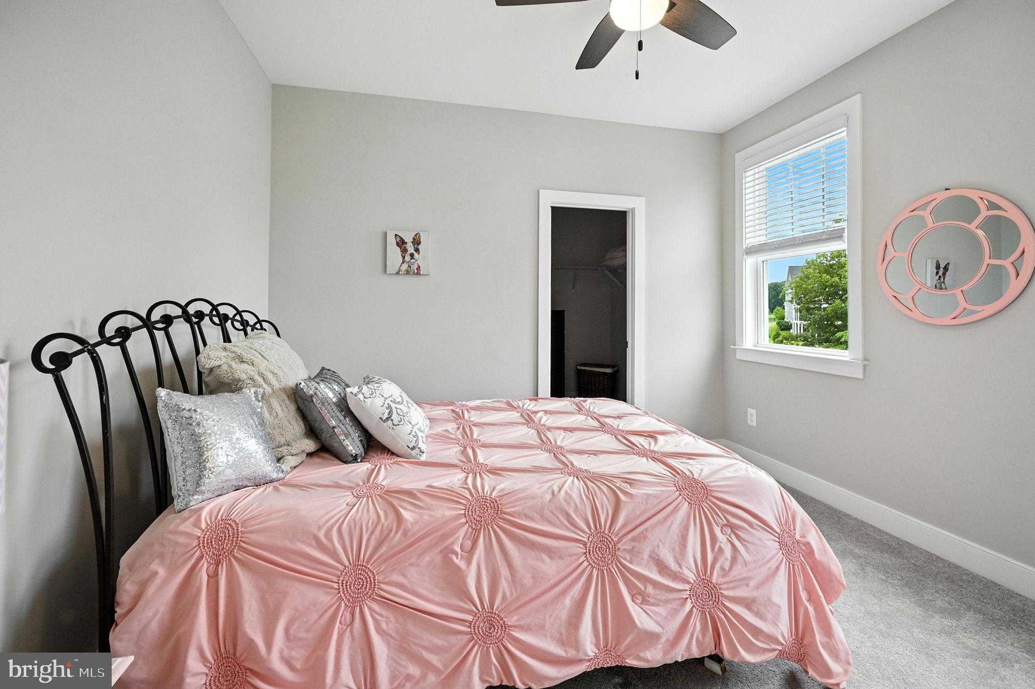 40960 River Cane Place Aldie, VA 20105 - Photo 33 of 54 a bedroom with a bed and a chandelier