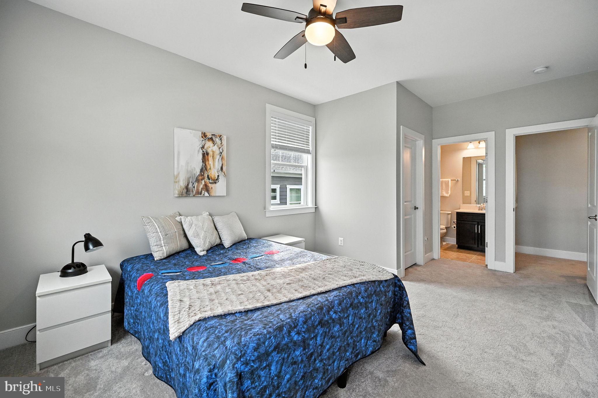40960 River Cane Place Aldie, VA 20105 - Photo 34 of 54 a bedroom with a bed and a chandelier