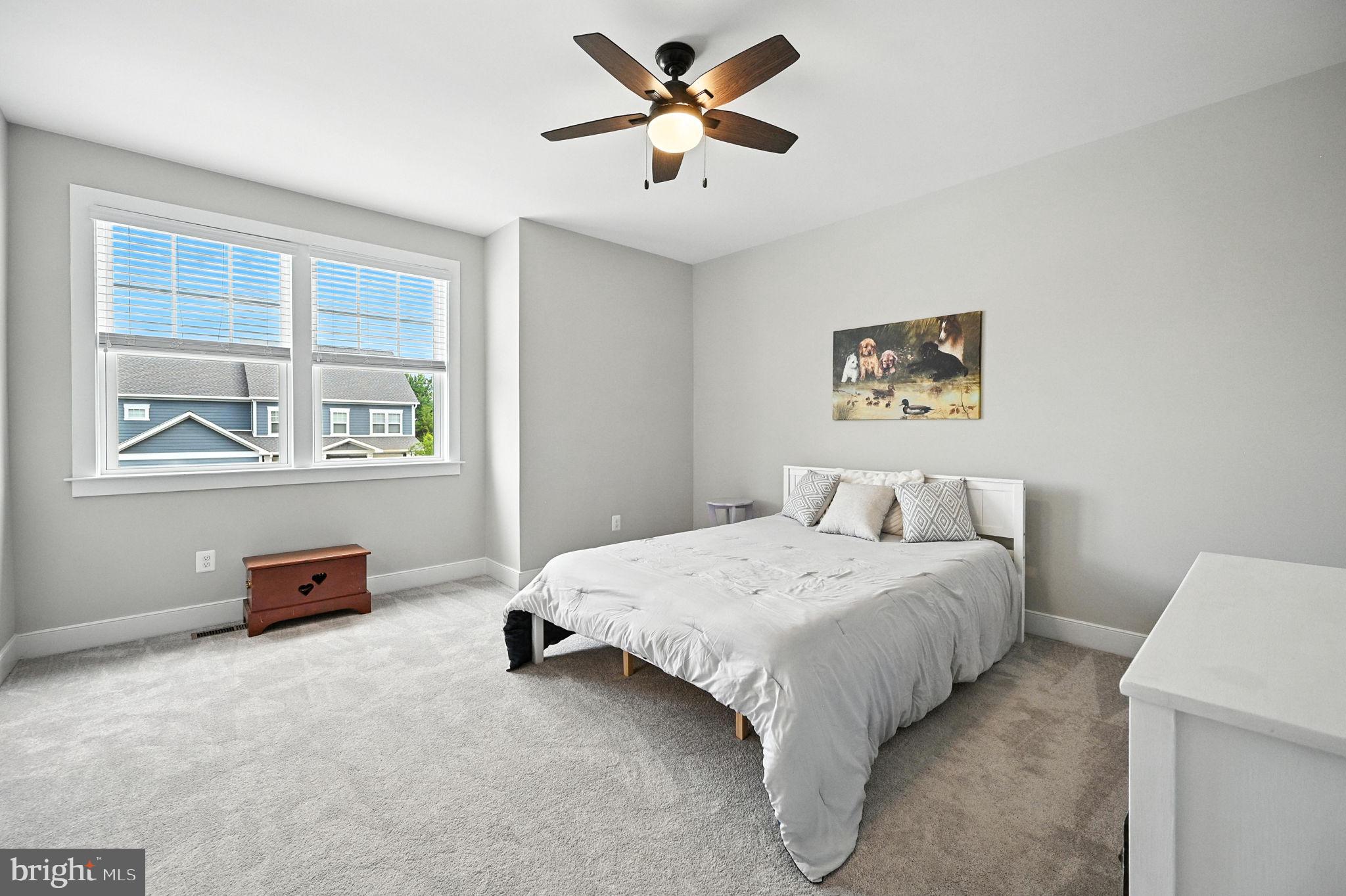 40960 River Cane Place Aldie, VA 20105 - Photo 36 of 54 a bedroom with a bed and a chandelier