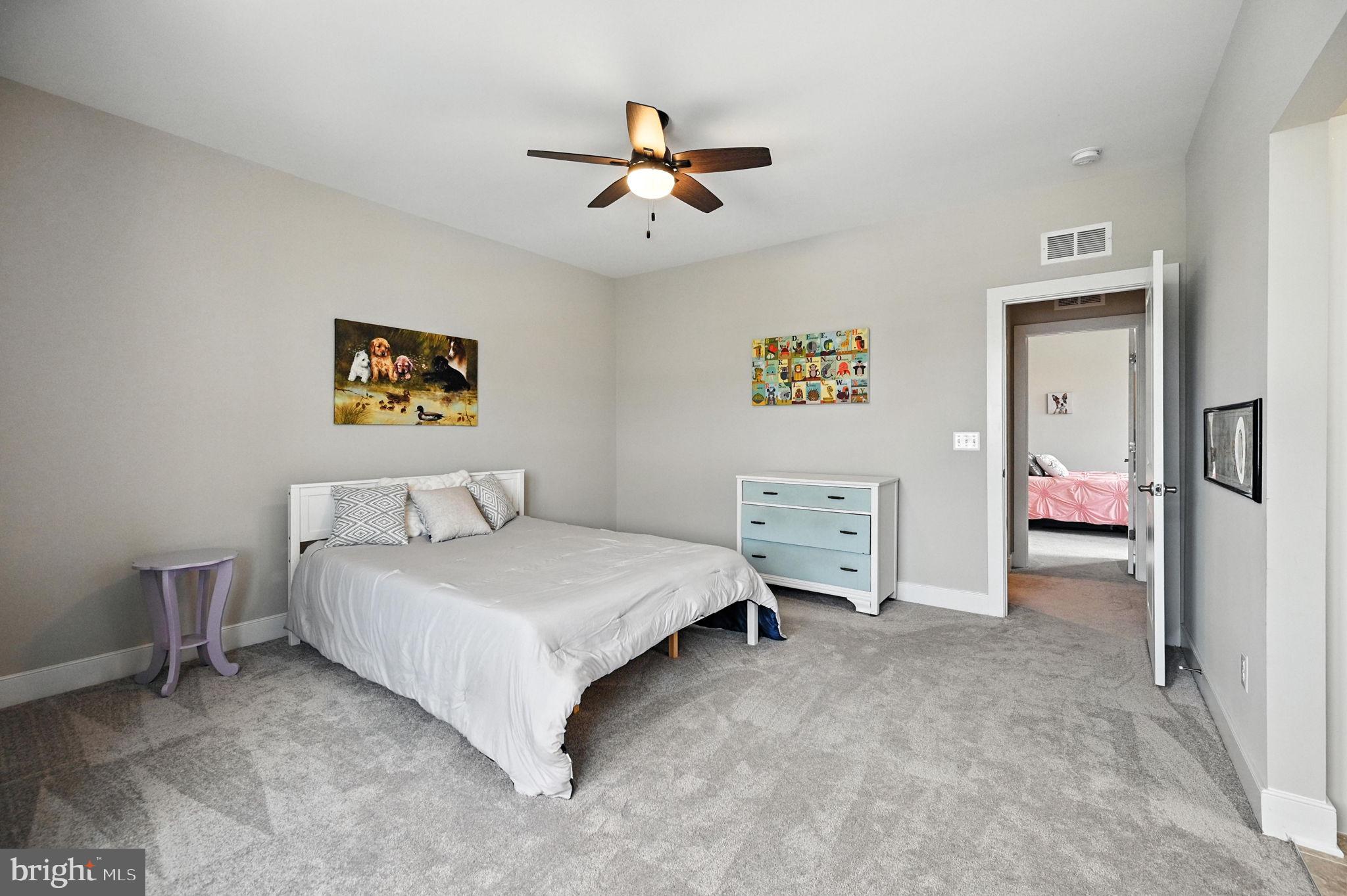 40960 River Cane Place Aldie, VA 20105 - Photo 41 of 54 a bedroom with a bed and a chandelier