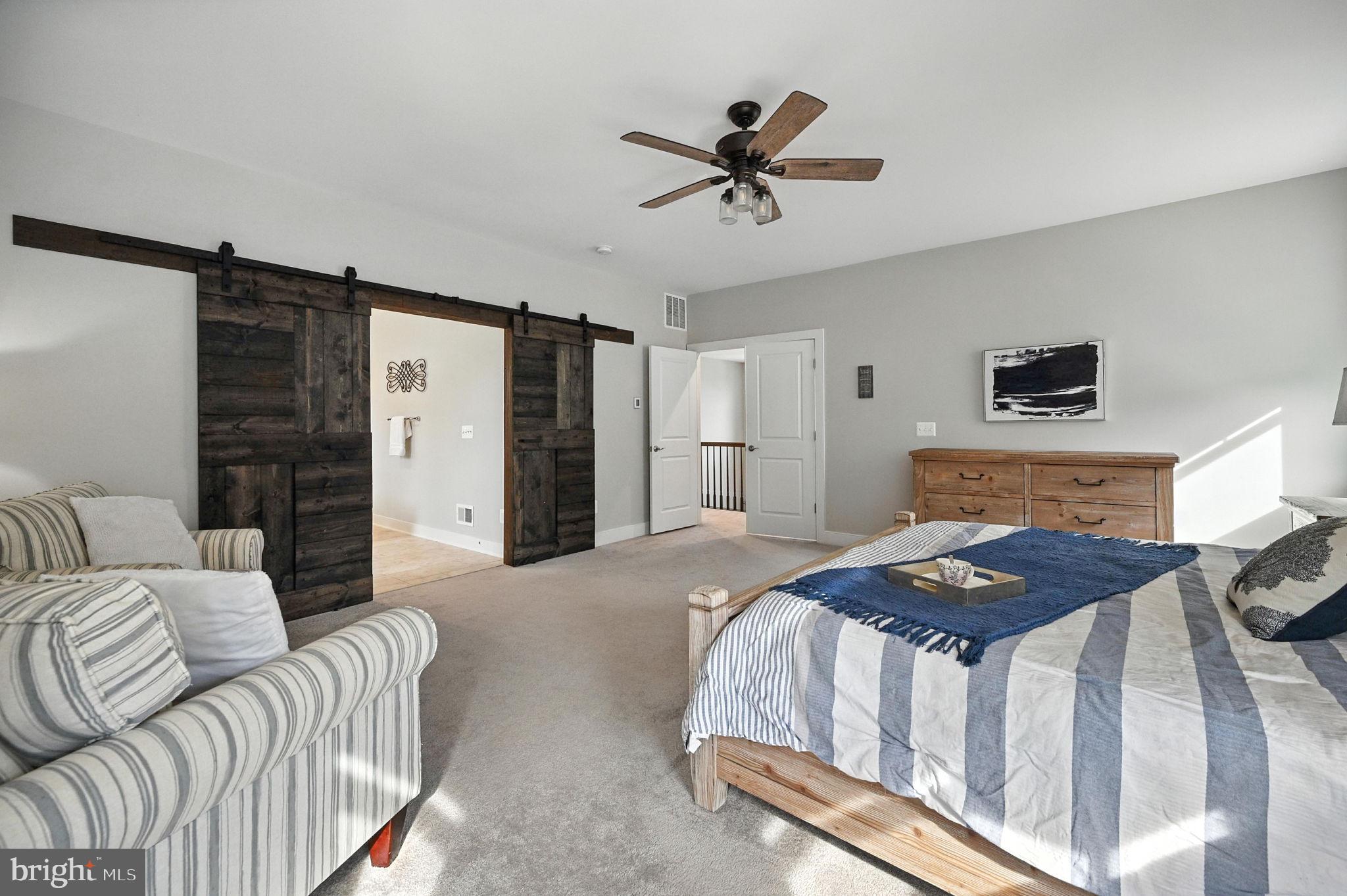 40960 River Cane Place Aldie, VA 20105 - Photo 42 of 54 a bedroom with a bed and a couch