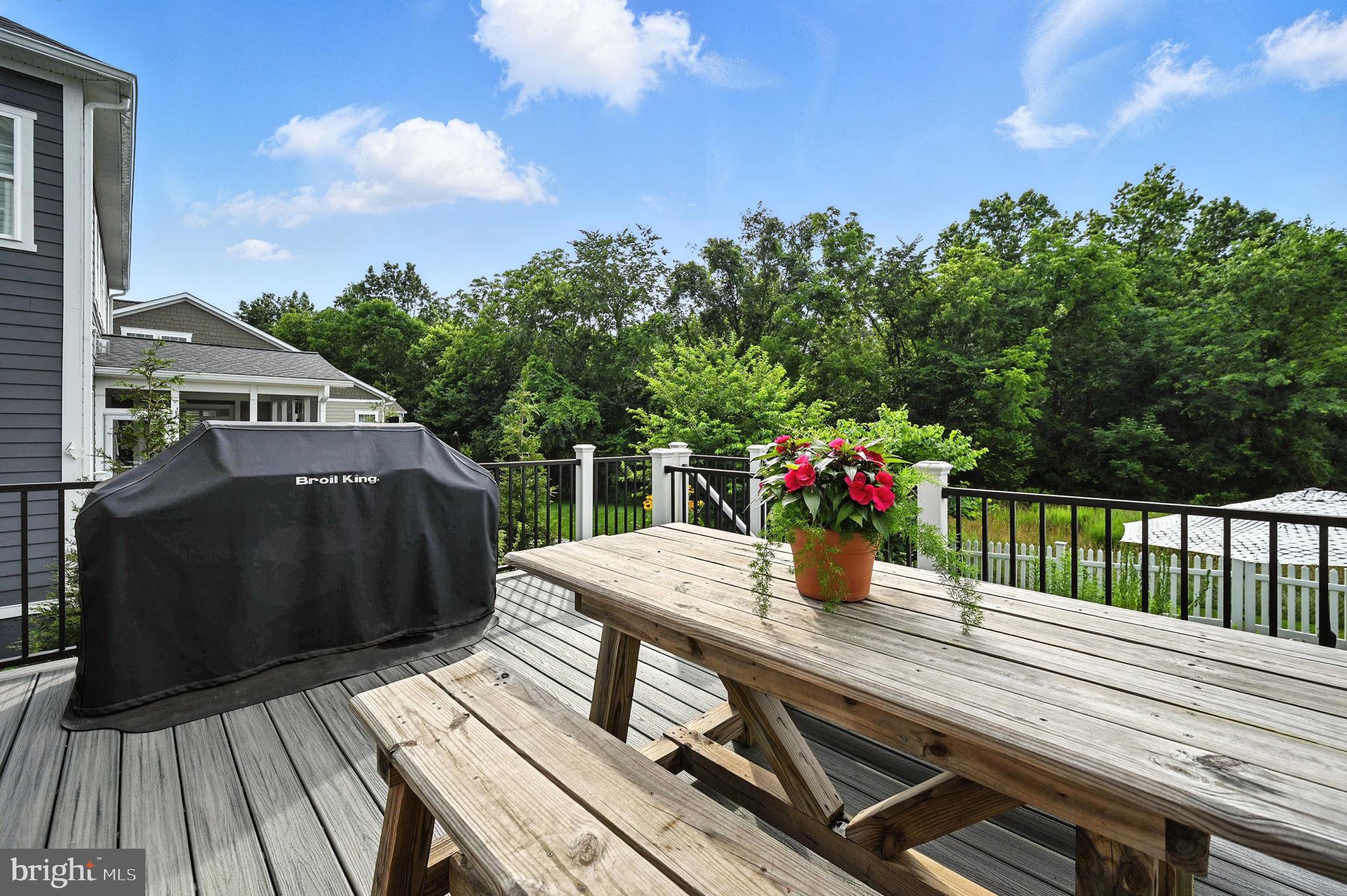 40960 River Cane Place Aldie, VA 20105 - Photo 44 of 54 a view of deck with table and chairs a barbeque with wooden floor and fence