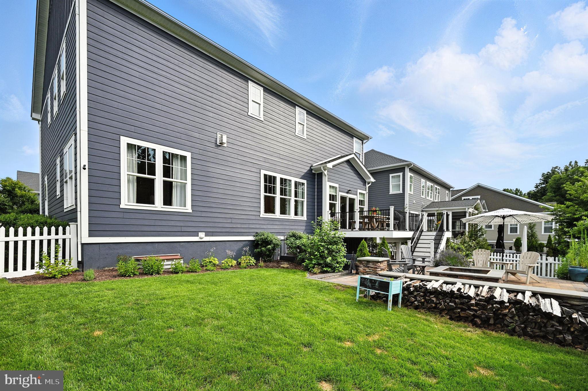 40960 River Cane Place Aldie, VA 20105 - Photo 49 of 54 a front view of a house with a garden and deck