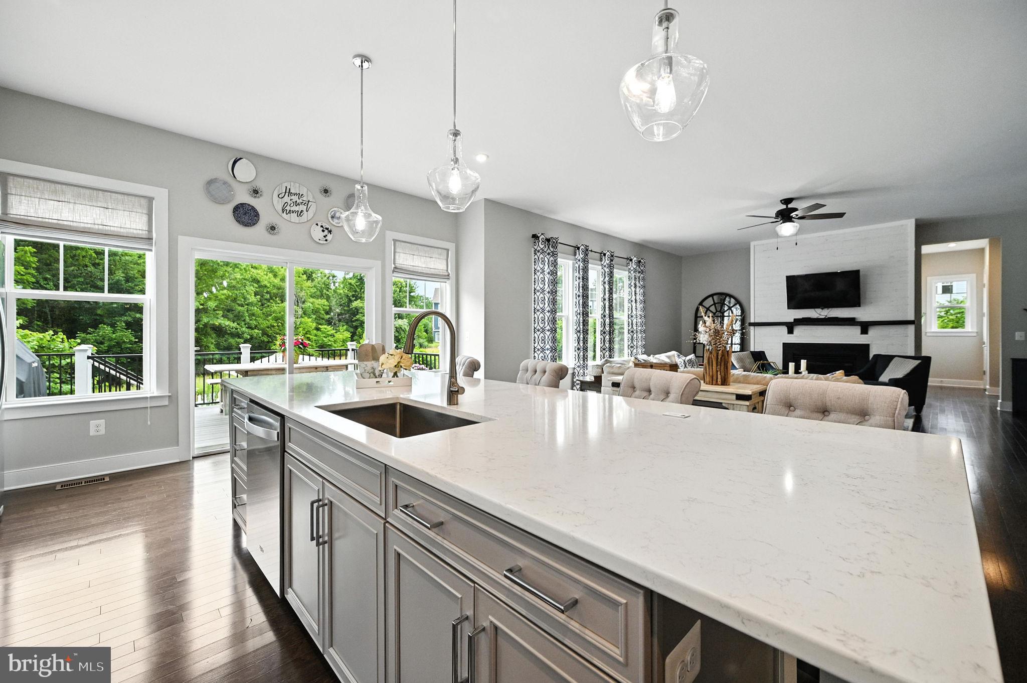 40960 River Cane Place Aldie, VA 20105 - Photo 7 of 54 a kitchen with kitchen island a large counter space a large window cabinets and stainless steel appliances