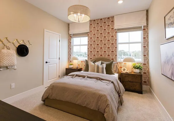 a bedroom with a bed and a chandelier