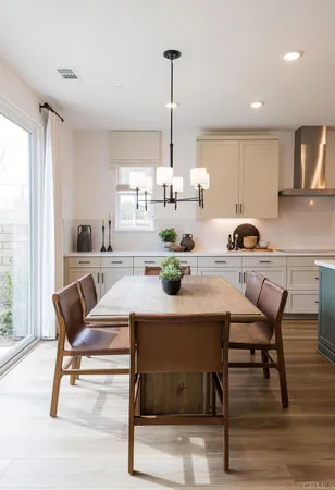 a dining room with furniture and wooden floor