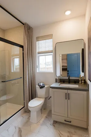 a bathroom with a toilet a sink and a mirror